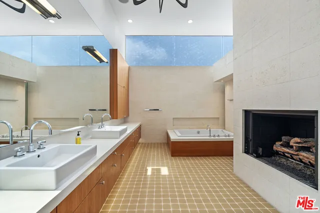 a bathroom with a double vanity sink and a mirror