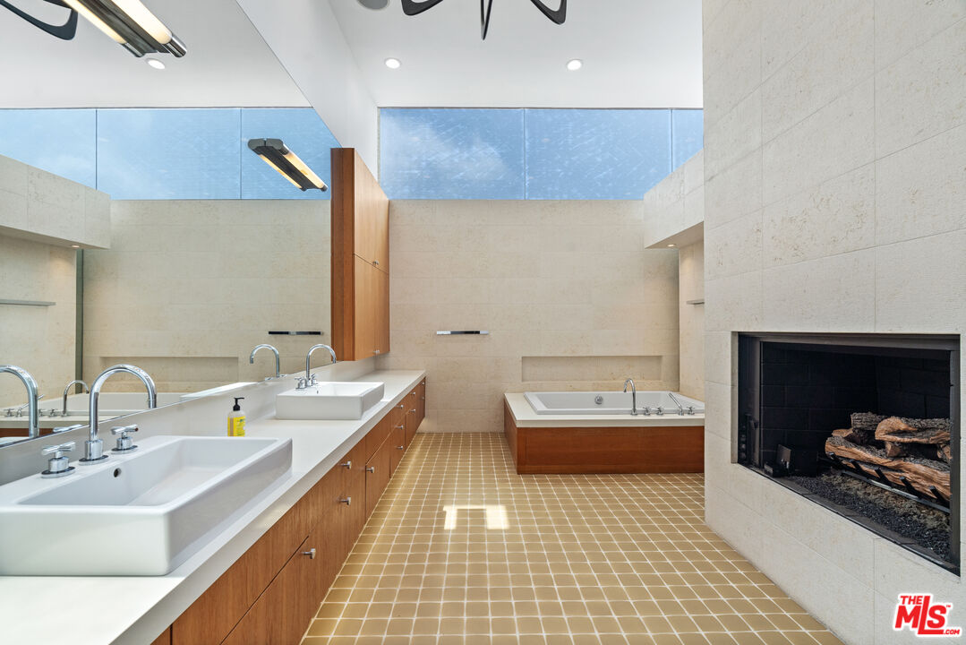 3817 Ocean Front Walk Marina del Rey, CA 90292 - Photo 11 of 25 a bathroom with a double vanity sink and a mirror