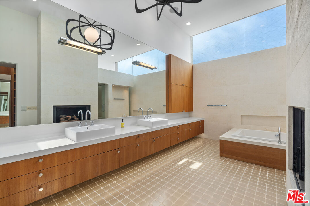 3817 Ocean Front Walk Marina del Rey, CA 90292 - Photo 12 of 25 a spacious bathroom with a double vanity sink and a mirror