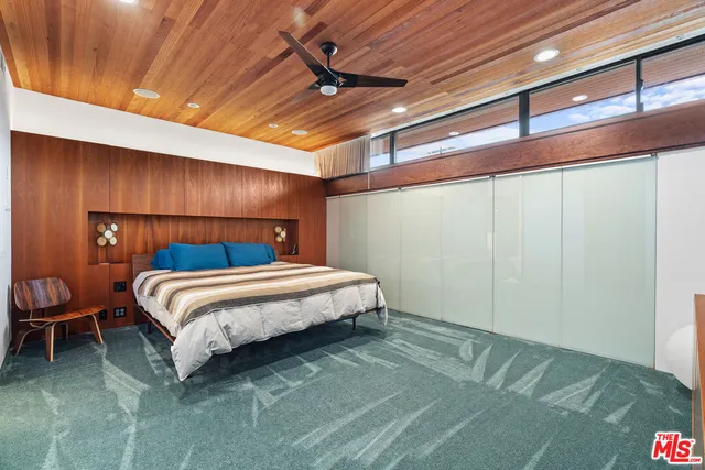 a bedroom with a bed and a table