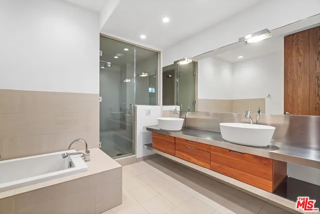 a bathroom with a bathtub sink and mirror
