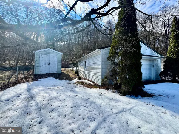 a view of a house with a yard covered with snow