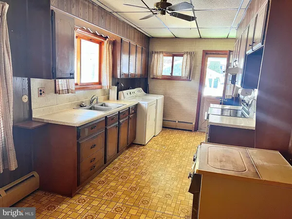 a bathroom with a granite countertop sink a mirror and a bathtub