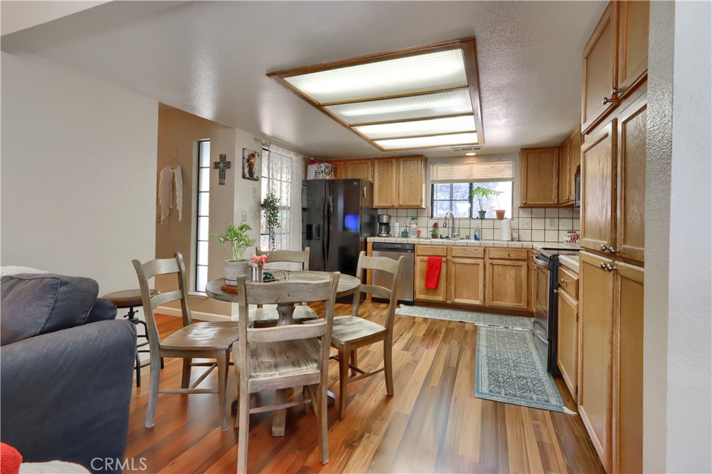 50840 Smoke Tree Trail Bass Lake, CA 93604 - Photo 15 of 36 a view of a dining room with furniture window and wooden floor