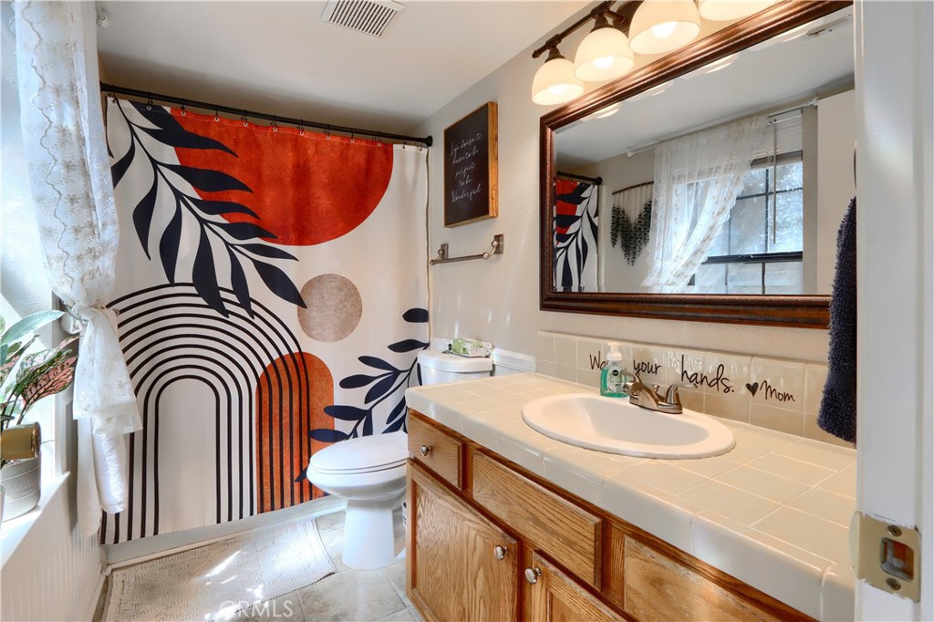 50840 Smoke Tree Trail Bass Lake, CA 93604 - Photo 21 of 36 a bathroom with a sink a mirror and a toilet