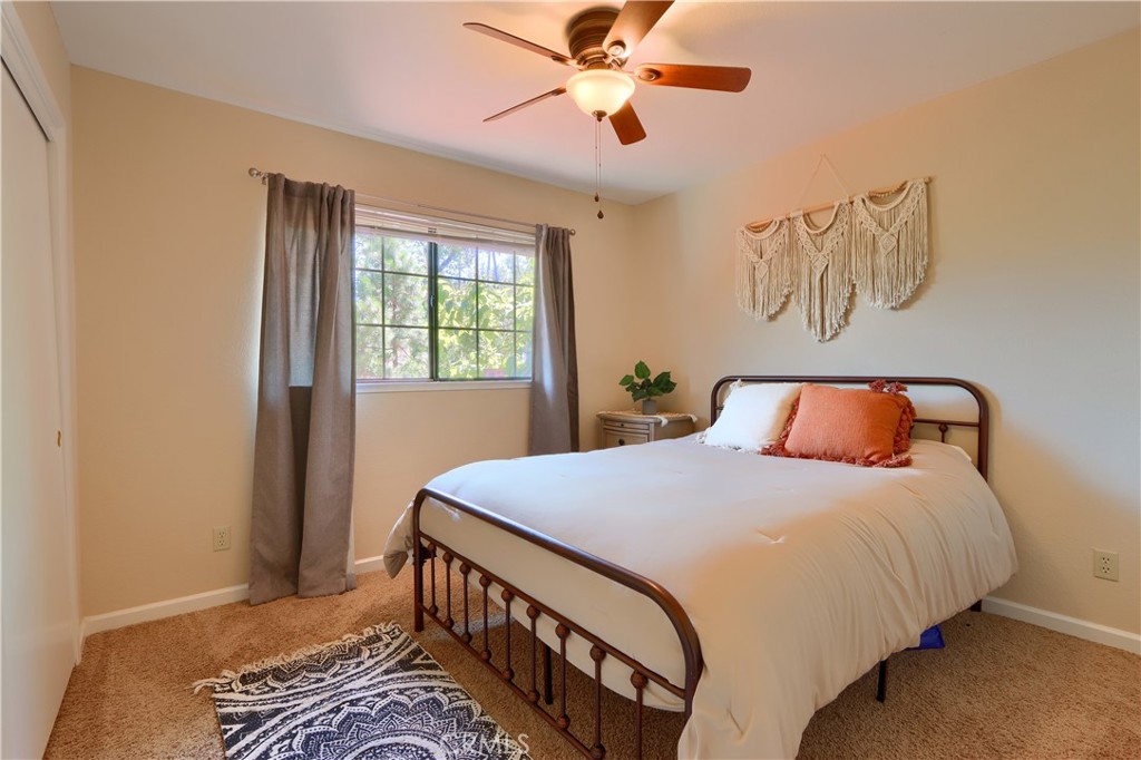 50840 Smoke Tree Trail Bass Lake, CA 93604 - Photo 23 of 36 a bedroom with a bed and a window