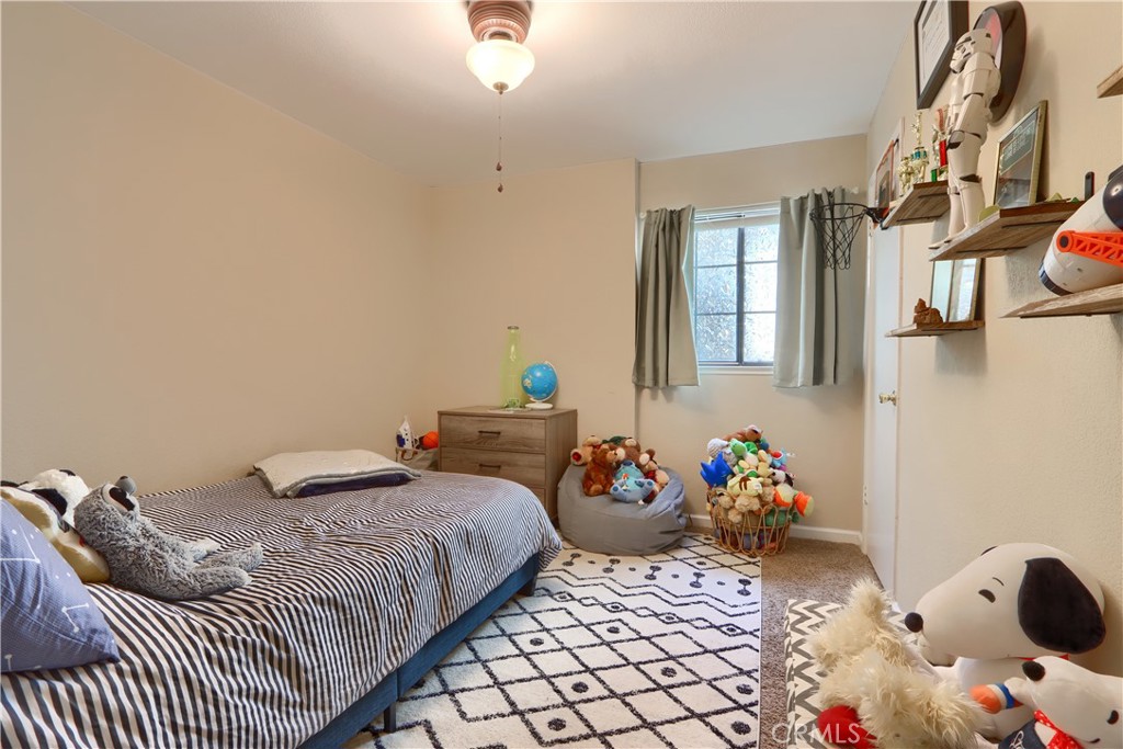 50840 Smoke Tree Trail Bass Lake, CA 93604 - Photo 25 of 36 a bedroom with a bed and wooden floor