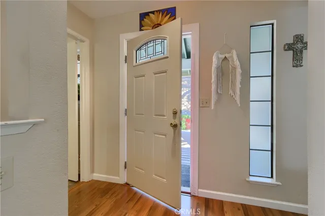 a view of a bedroom with wooden floor
