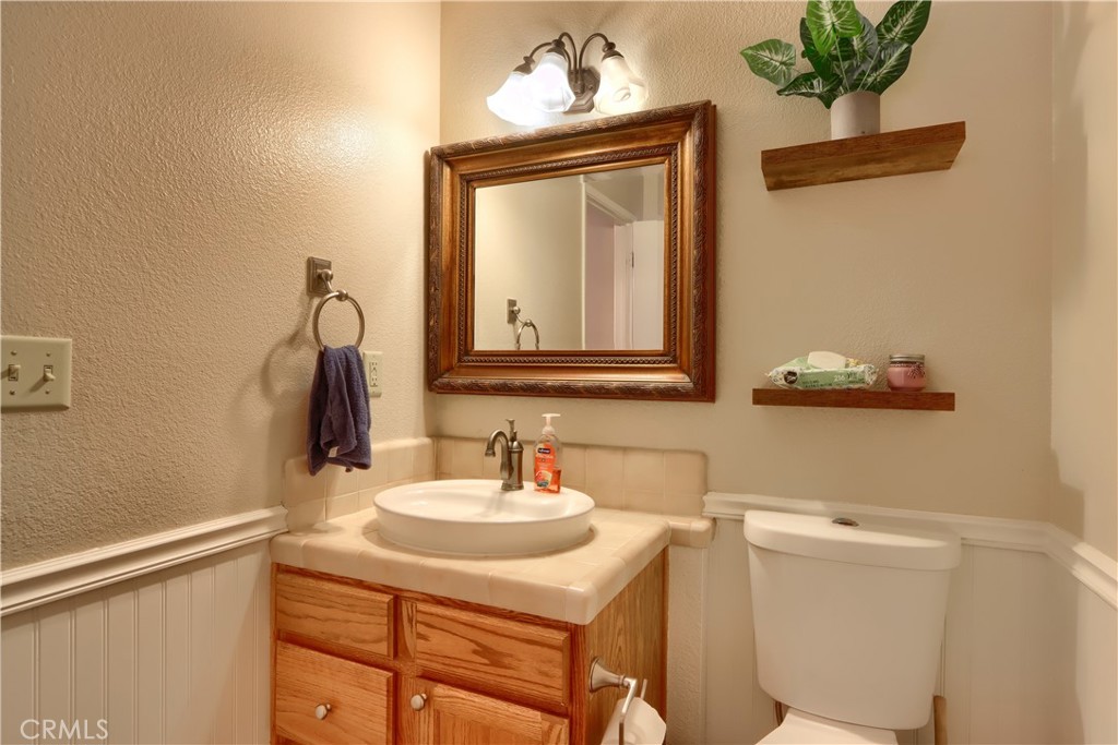 50840 Smoke Tree Trail Bass Lake, CA 93604 - Photo 7 of 36 a bathroom with a sink a mirror and a toilet