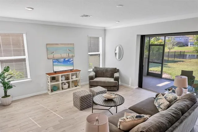 a living room with furniture and a large window