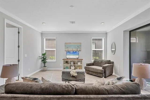 a living room with furniture and a large window