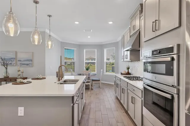 a kitchen with stainless steel appliances a stove sink and cabinets