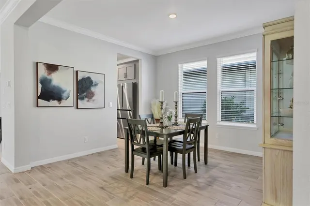 a view of a dining room with furniture and window