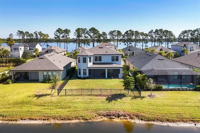 a view of a swimming pool and a lawn chairs under an umbrella