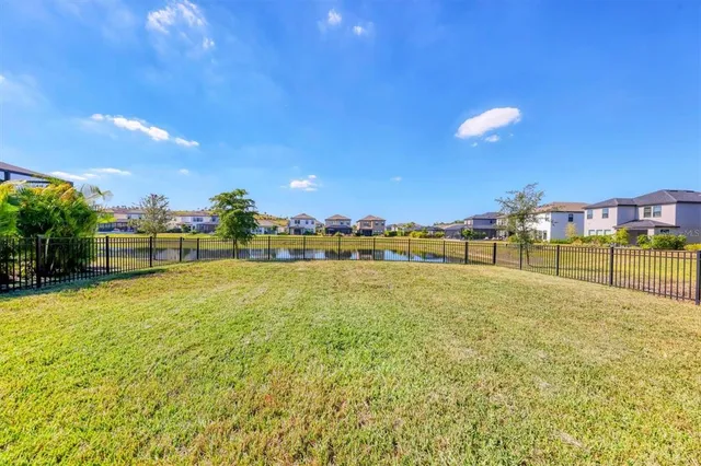 an aerial view of a house with a swimming pool yard and outdoor seating