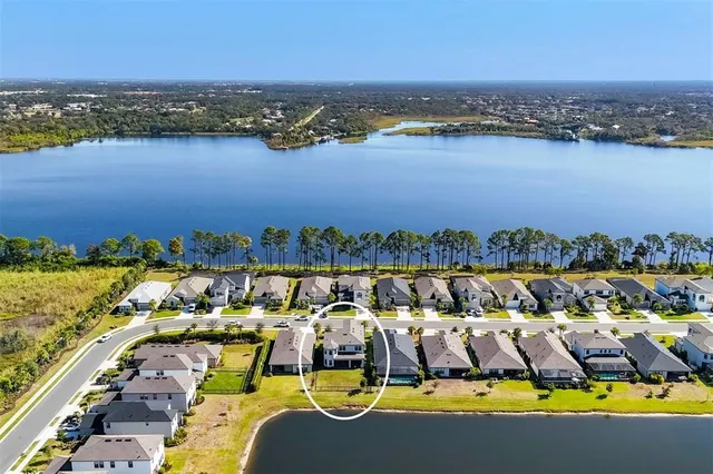 a view of a swimming pool with a table and chairs under an umbrella