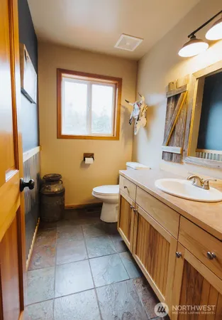 a bathroom with a toilet sink and mirror