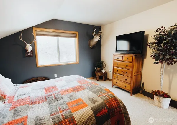a living room with fireplace furniture and a flat screen tv