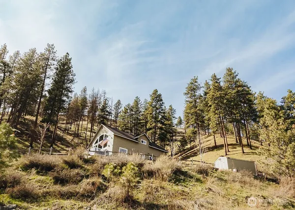 a view of backyard with wooden fence