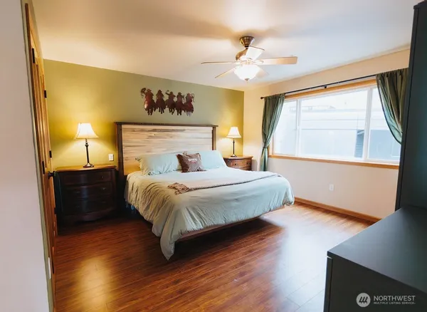 a bedroom with a large bed and a chandelier