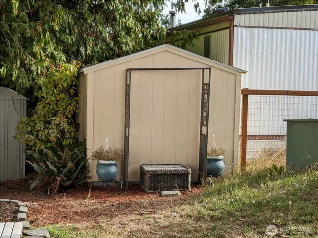 a backyard of a house with chairs