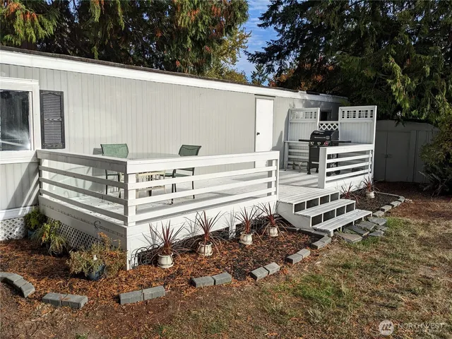 a view of a backyard with chairs and a yard