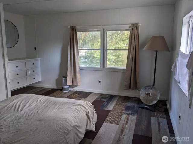 a bedroom with a bed and a window