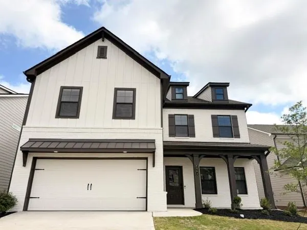 a front view of a house with garage