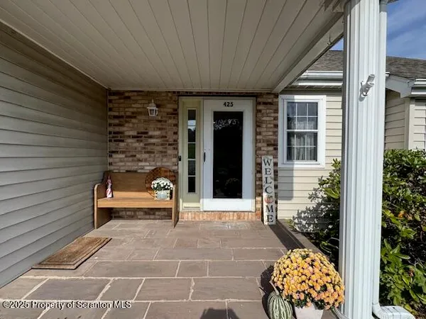 a front view of a house with a yard and seating space