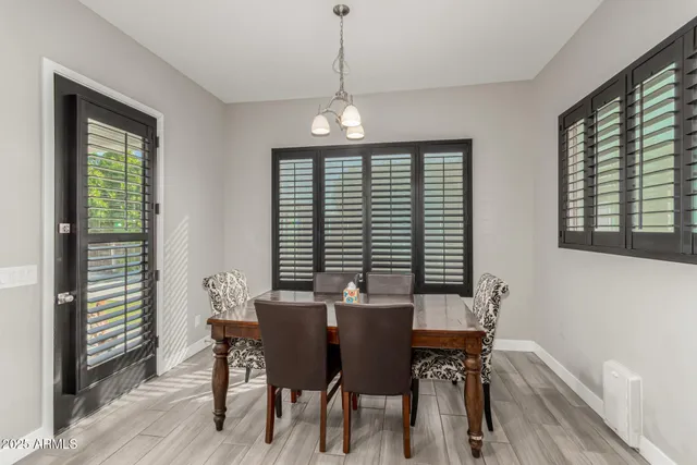 a large kitchen with a sink a counter top stainless steel appliances and cabinets