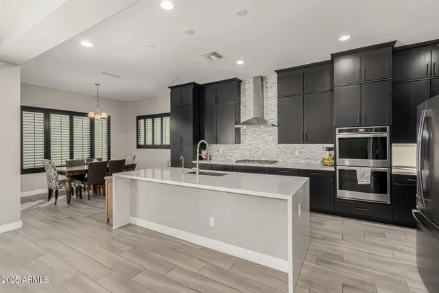 a kitchen with stainless steel appliances a sink stove and refrigerator