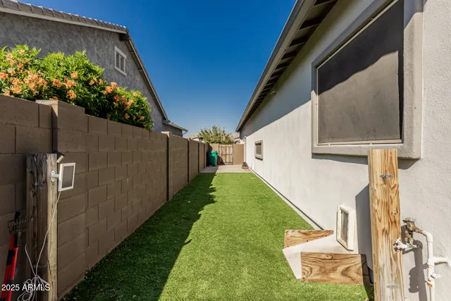 a view of a patio with a table and chairs under an umbrella