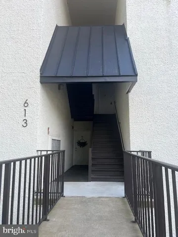a view of a house with a wooden fence