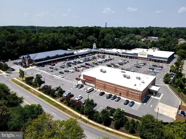 a swimming pool with outdoor seating and a potted plant