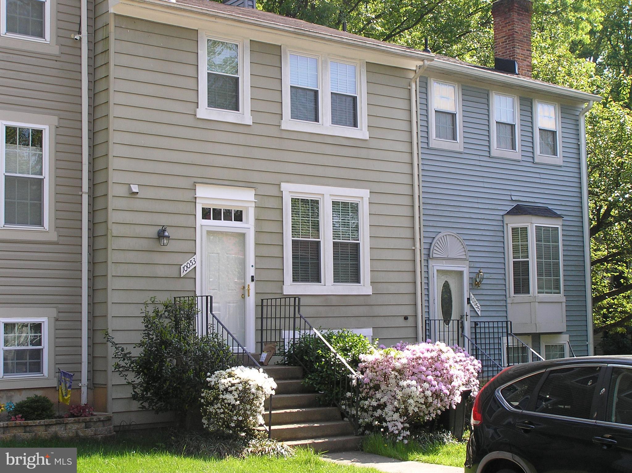 10053 Chestnut Wood Lane Burke, VA 22015 - Photo 1 of 28 a front view of a house with a yard and a garage