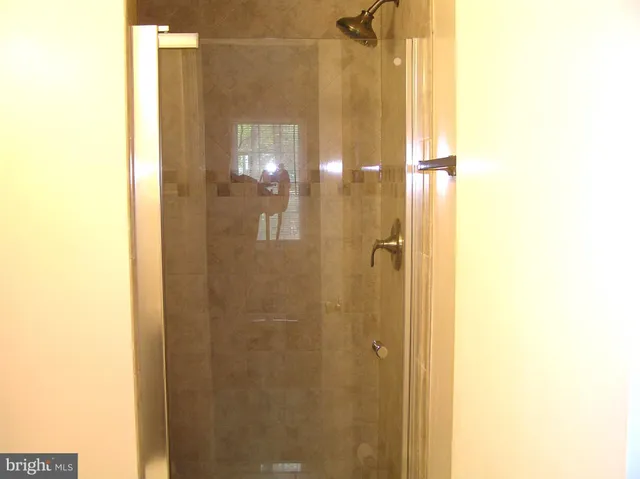 a bathroom with a glass shower door