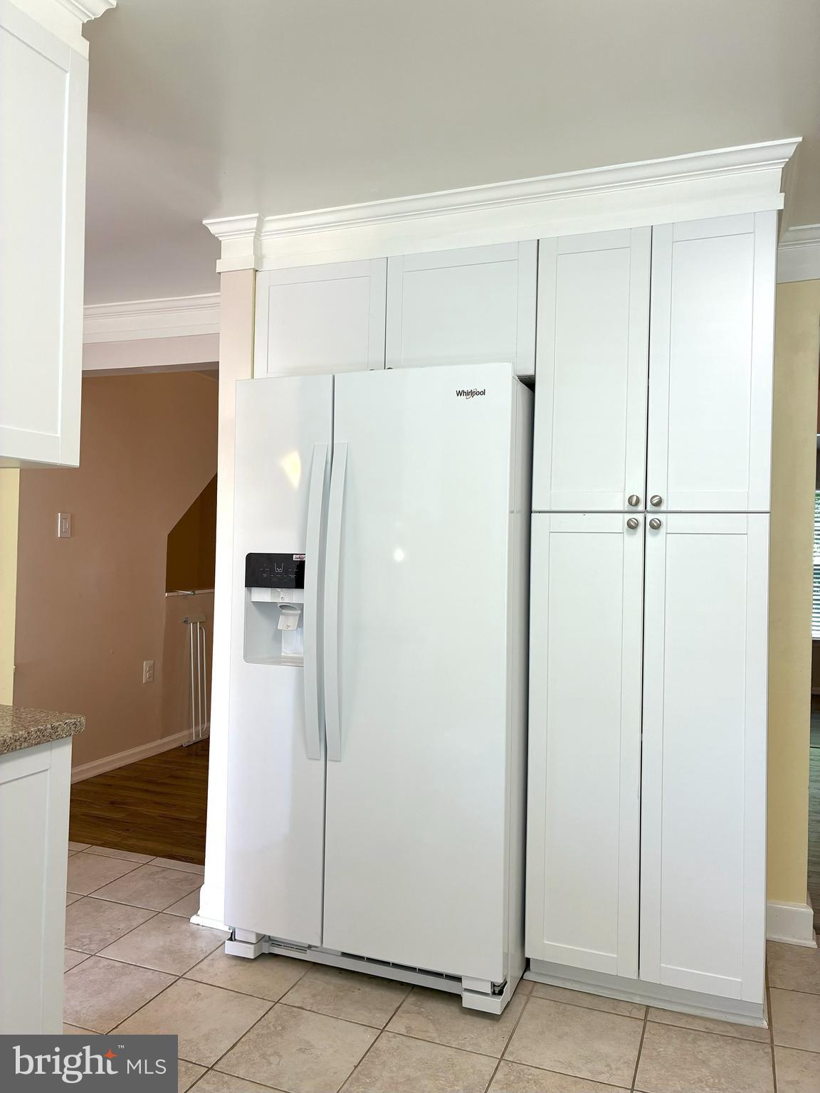 10053 Chestnut Wood Lane Burke, VA 22015 - Photo 4 of 28 a white refrigerator freezer sitting in a kitchen