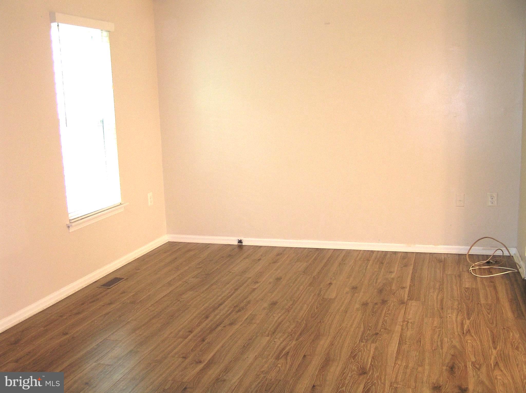 10053 Chestnut Wood Lane Burke, VA 22015 - Photo 8 of 28 an empty room with wooden floor and windows