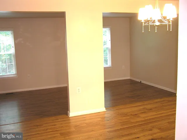 an empty room with wooden floor