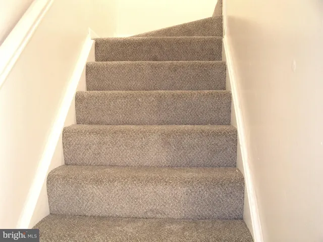 a living room with a couch and a walk in closet
