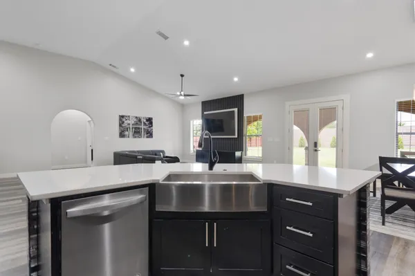 a kitchen with stainless steel appliances a sink and a refrigerator