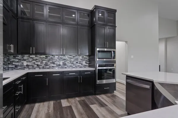 a kitchen with stainless steel appliances wooden cabinets and granite counter tops