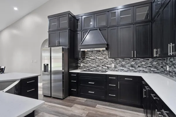 a kitchen with stainless steel appliances granite countertop a refrigerator and a sink