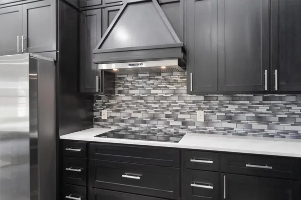 a kitchen with a sink and a refrigerator