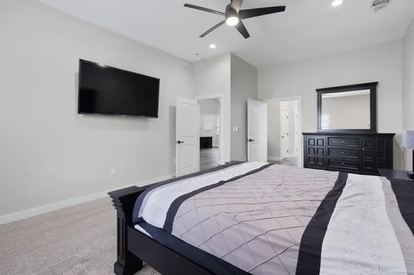 a bedroom with a bed and a flat screen tv