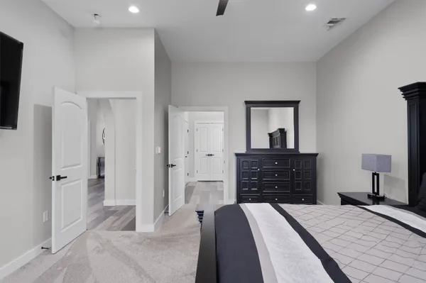 a bedroom with a bed and a dresser