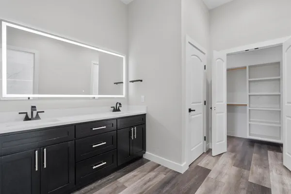 a bathroom with a double vanity sink and mirror