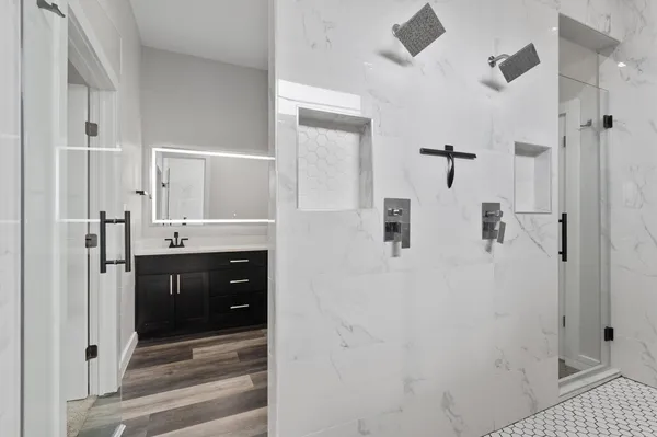 a bathroom with a double vanity sink shower and mirror