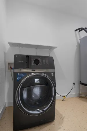 a utility room with washing machine