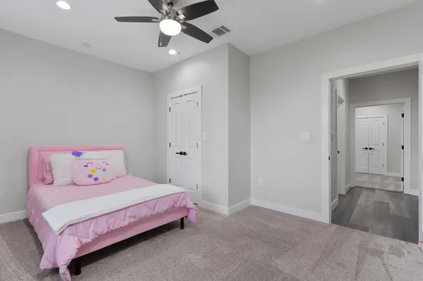 a bedroom with a bed and a chandelier